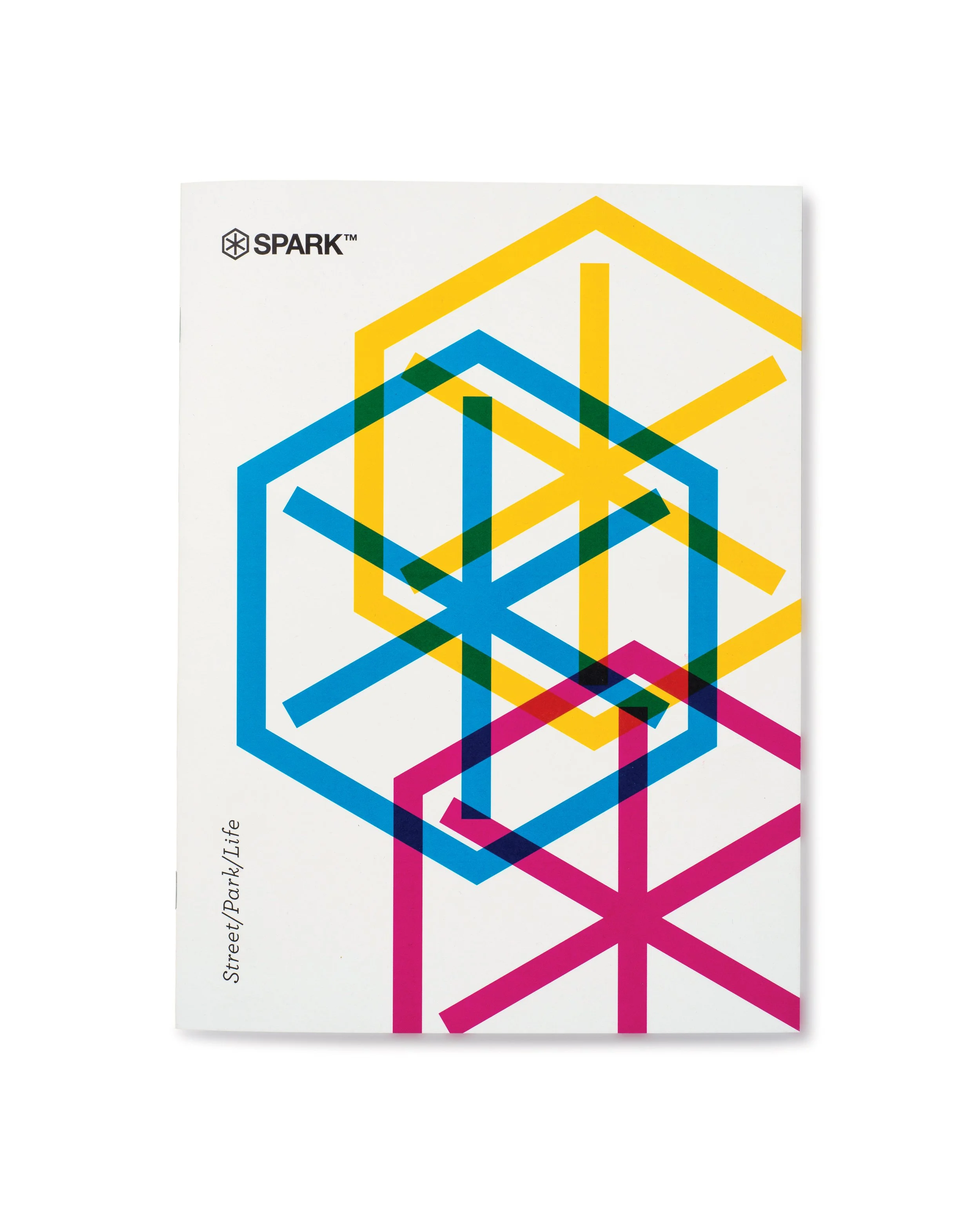 Close-up of a packet of Spark brand breath strips with colorful geometric design on white background.