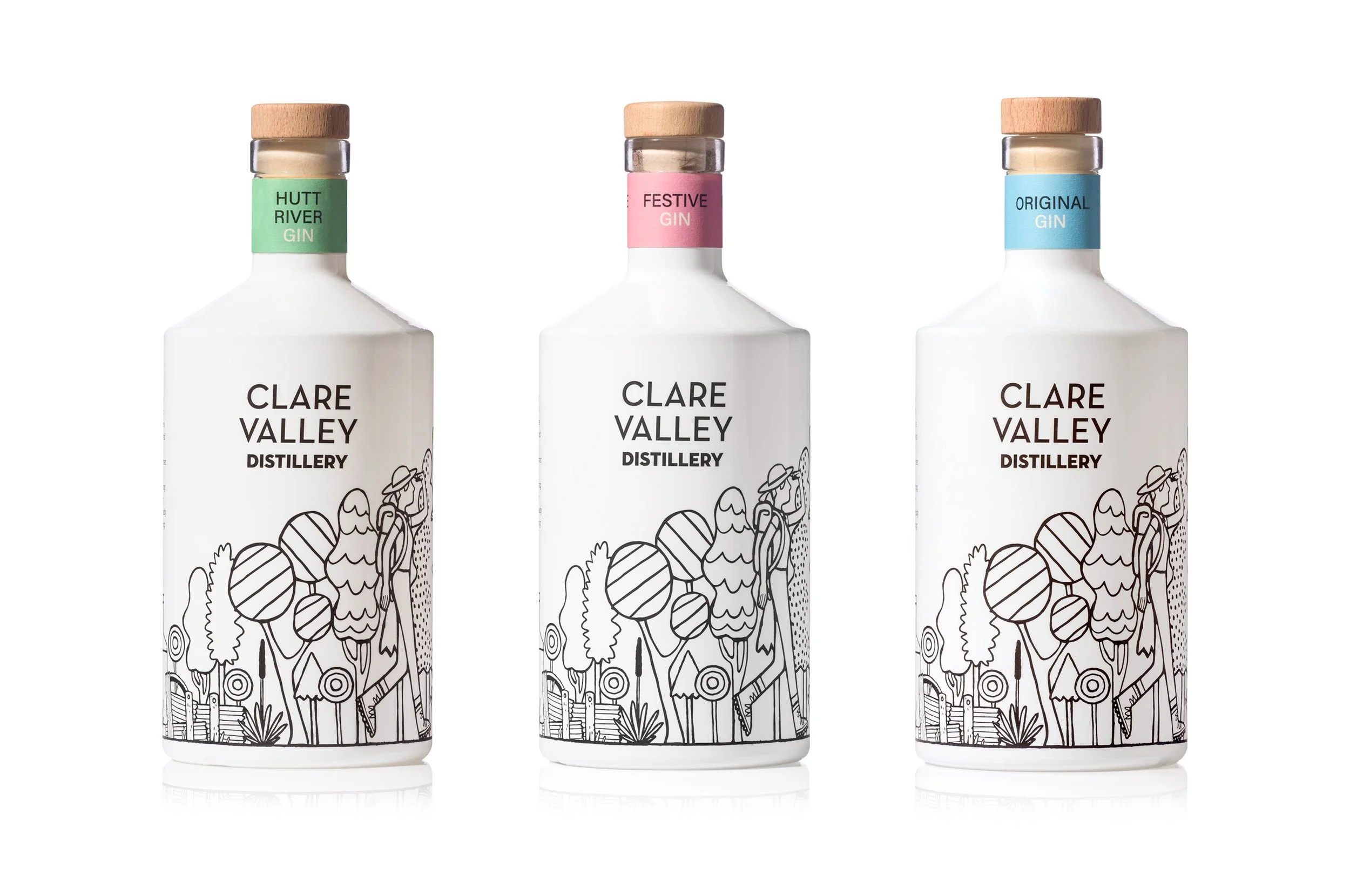 Three bottles of Clare Valley Distillery gin with colorful labels and wooden caps, featuring black and white line art illustrations on the bottles.