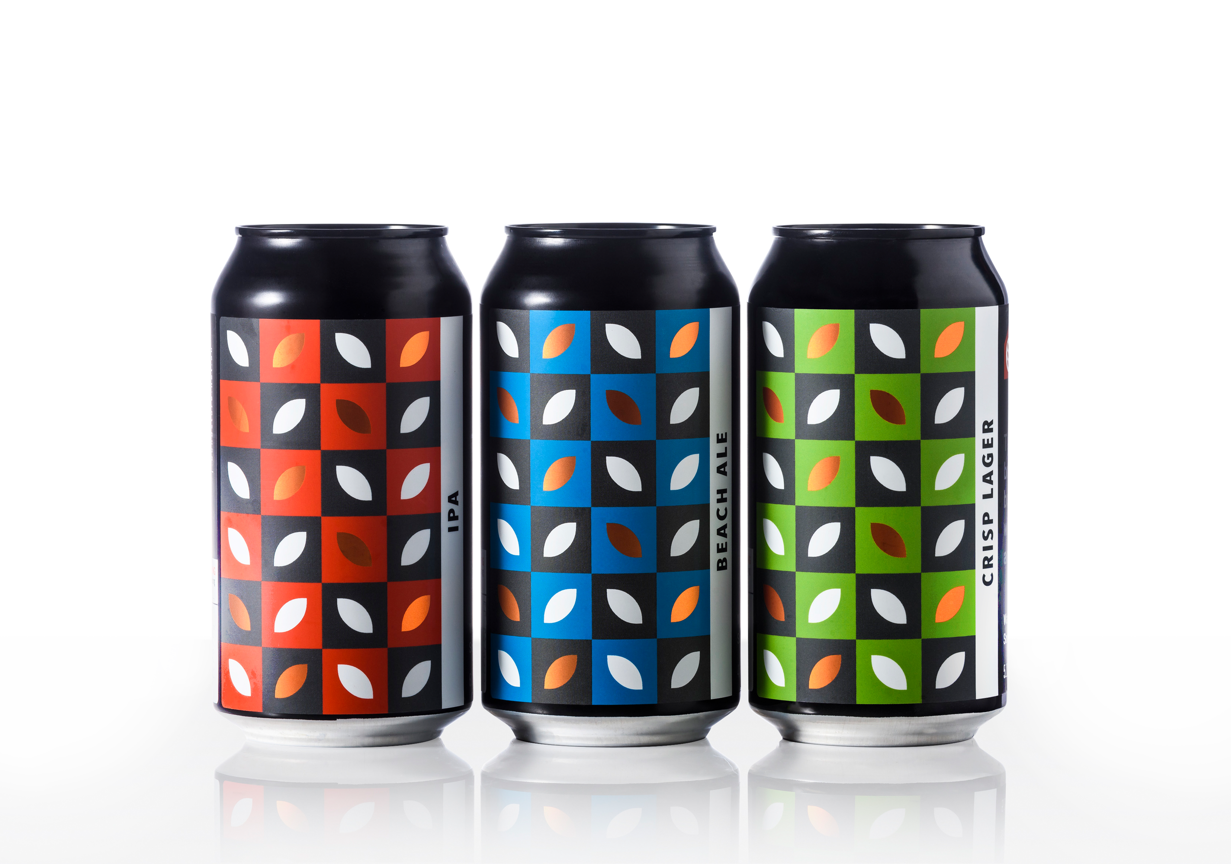 Three black cans with colorful, patterned labels featuring leaf motifs, standing side by side against a white background.
