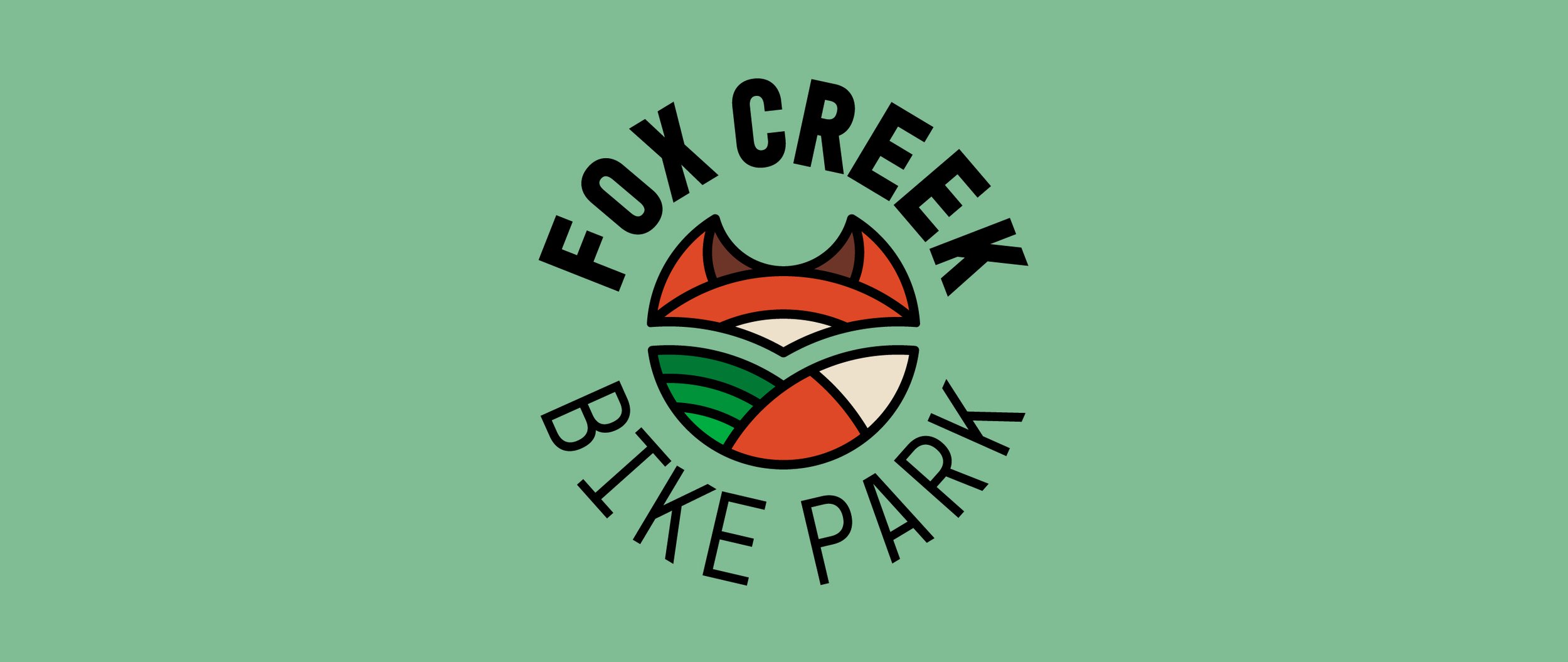 A logo for Fox Creek Bike Park featuring a stylized fox face with orange, black, and white colors, and a circular background with green and black elements. The text reads 'Fox Creek Bike Park' in a circular arrangement around the fox face.