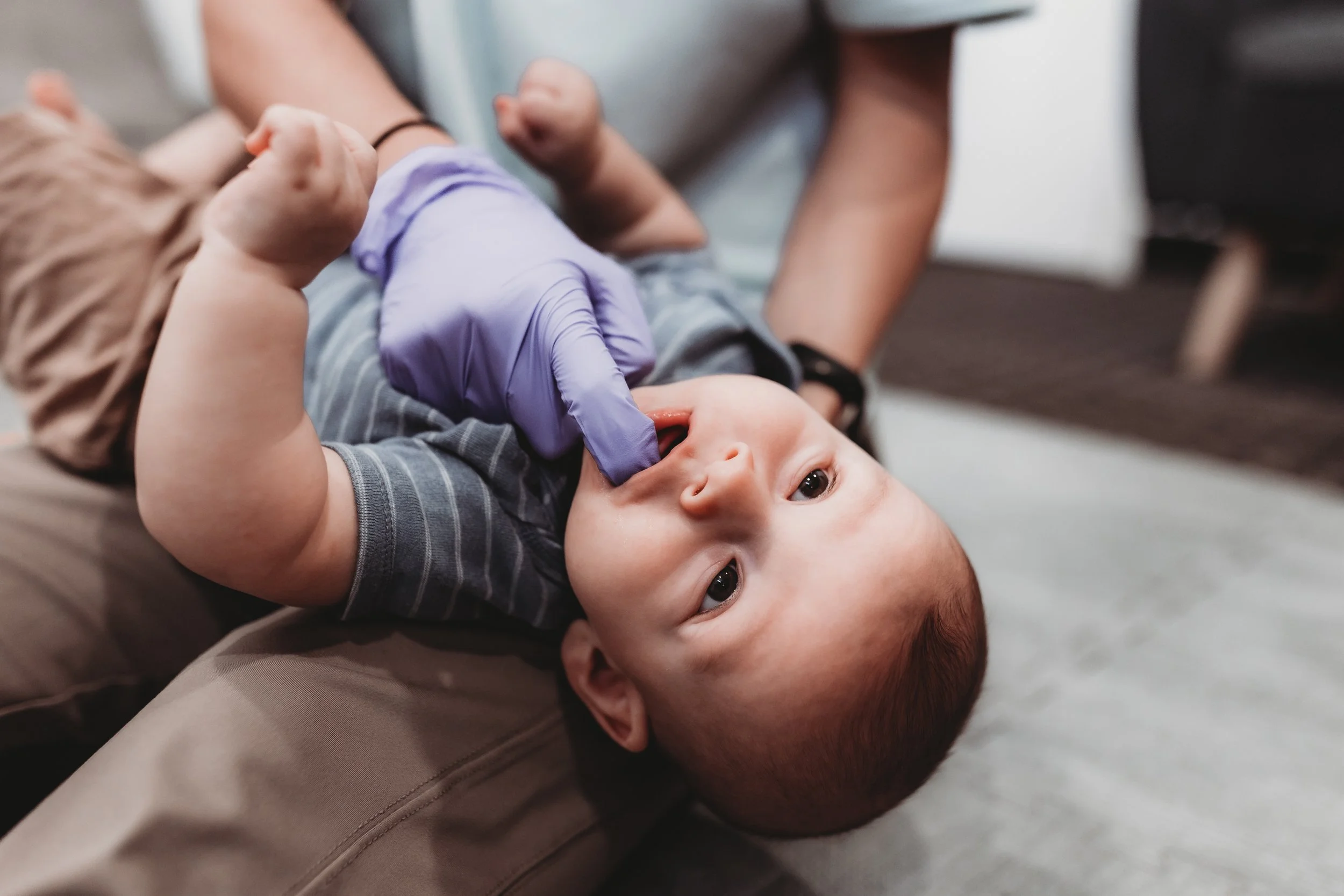 Feeding therapist performing infant oral motor assessment during lactation and feeding therapy session in Pasco County Florida