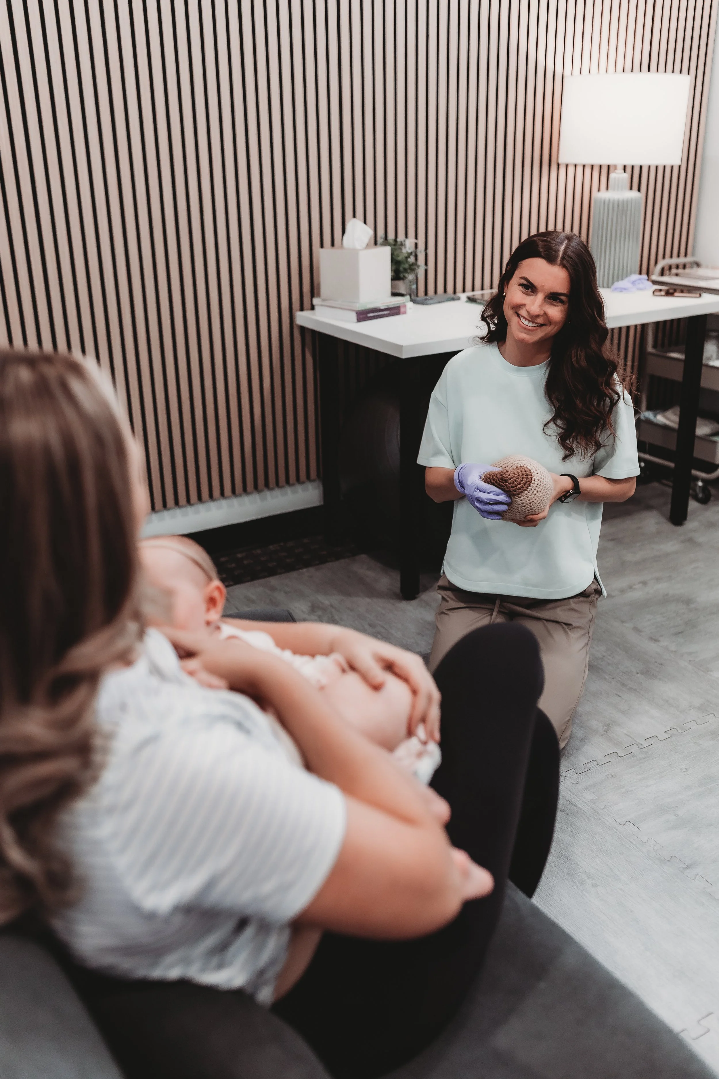 IBCLC lactation consultant providing breastfeeding education to mother and infant during consultation in New Port Richey Florida