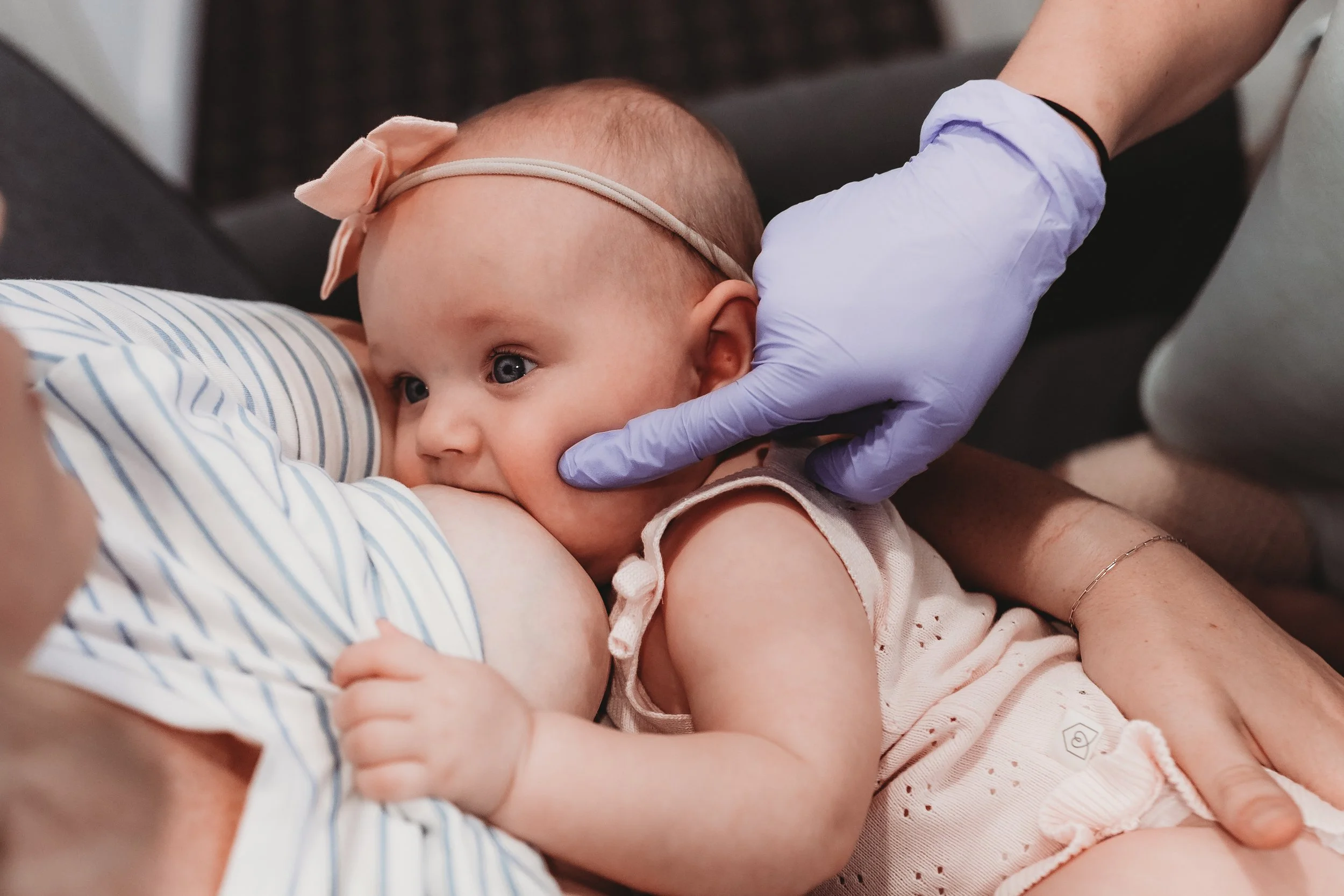 IBCLC providing hands-on latch support during breastfeeding session at Blue Door Holistic Therapy and Lactation