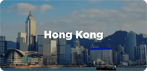 Hong Kong skyline with skyscrapers and a harbor in the foreground.