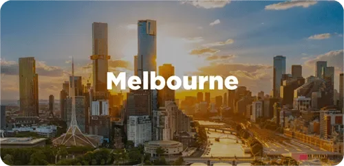 Sunset over Melbourne city skyline with tall buildings and a river.