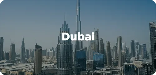 Skyline of Dubai featuring the Burj Khalifa skyscraper amid numerous tall buildings under a clear blue sky.