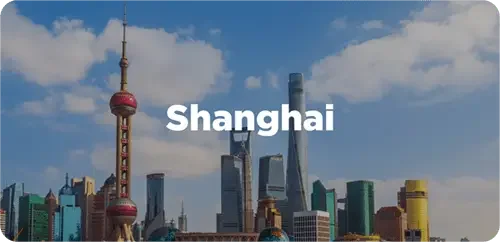 Skyline of Shanghai with tall skyscrapers and the Oriental Pearl Tower under a partly cloudy sky, with the word 'Shanghai' overlaid.