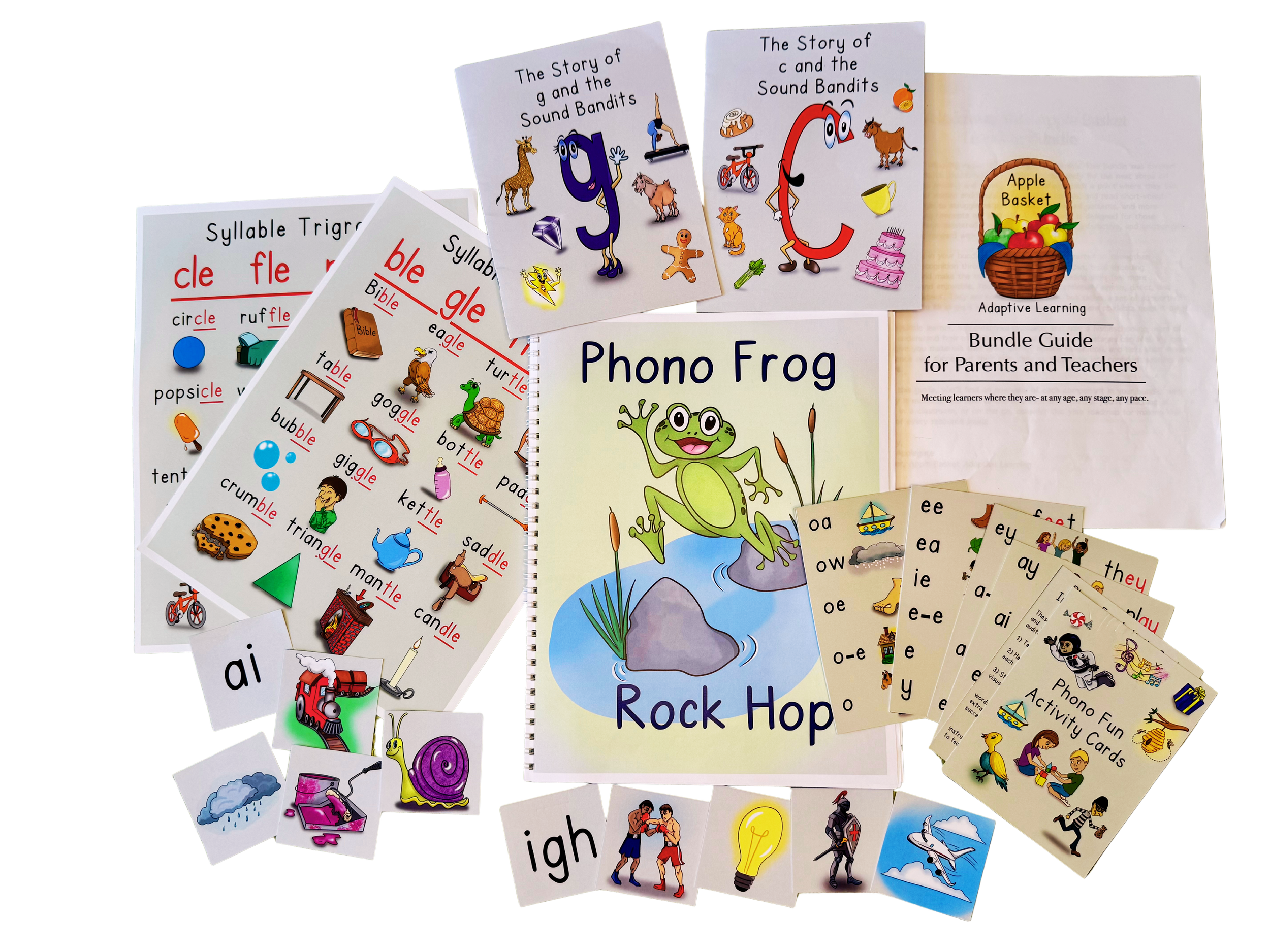 Collection of children's educational books and flashcards, including picture books, phonics guides, and activity cards, scattered on a black surface.