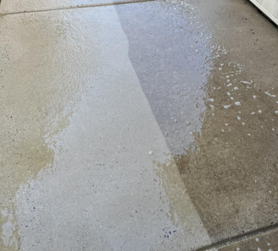 Wet and dry concrete floor with a visible line showing the transition between the two areas.