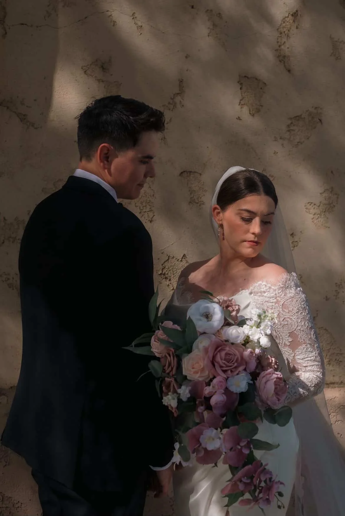 Romantic bride with soft glam makeup and classic updo holding bouquet at Petite Ever After in Moorpark