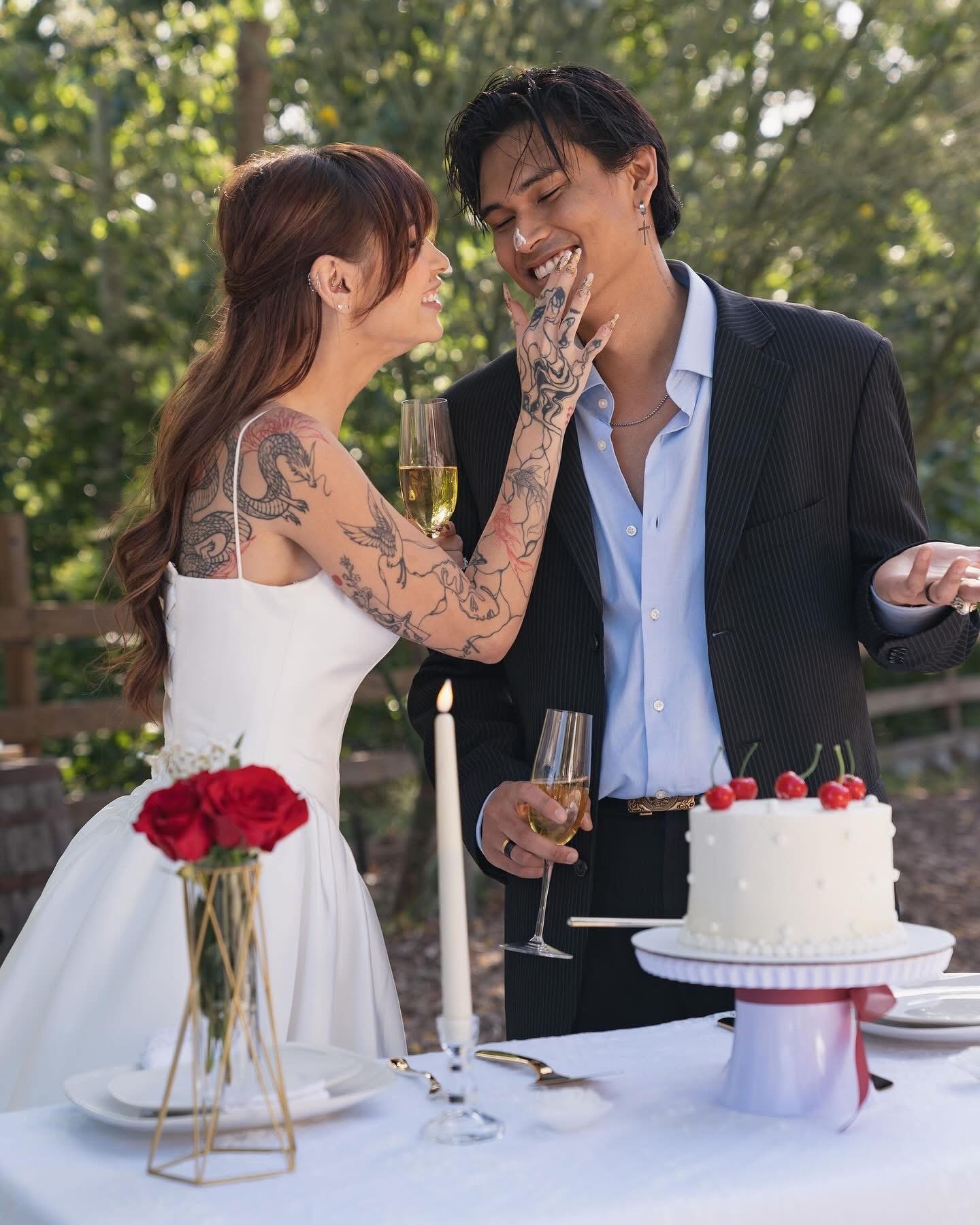 Bride and groom laughing together while cutting wedding cake during an outdoor California wedding