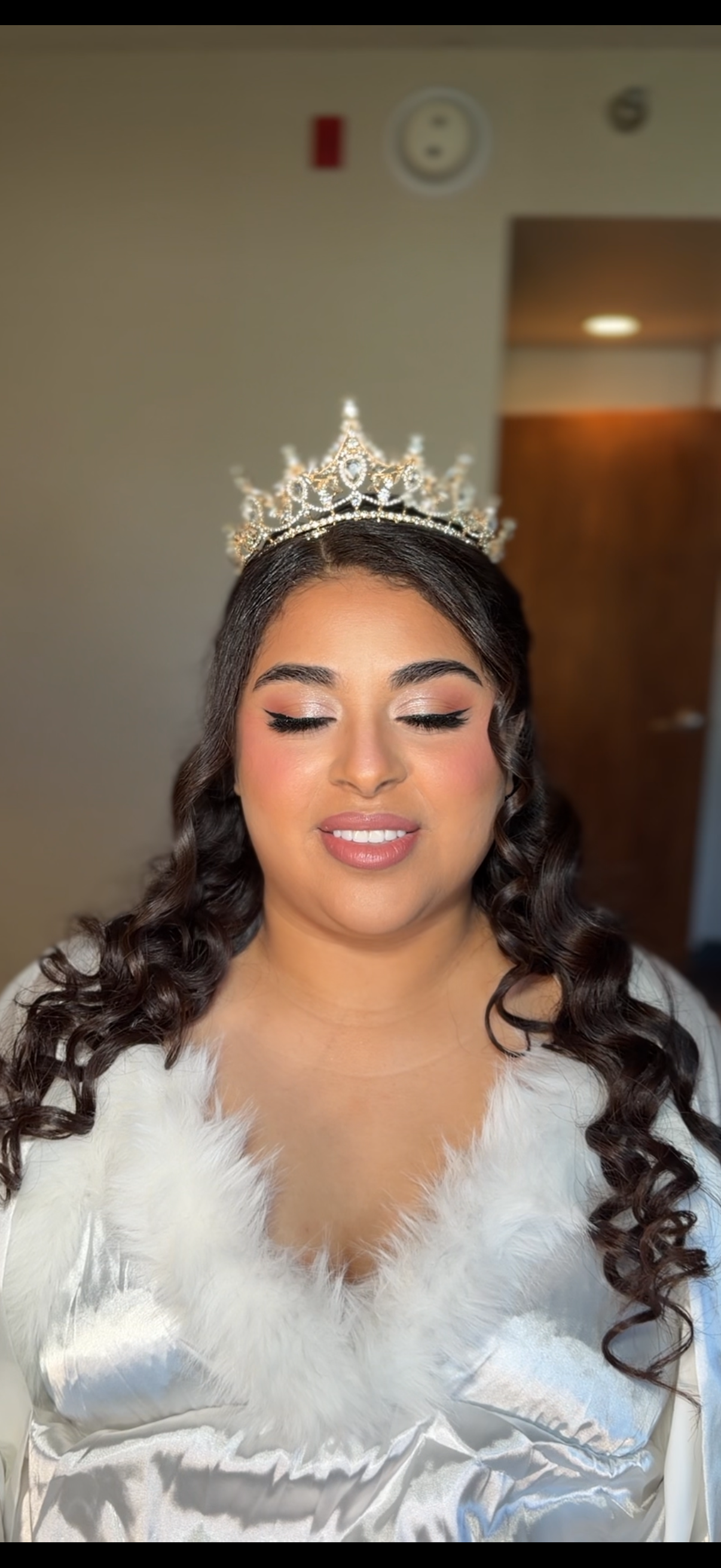Glam bridal makeup with long romantic curls and tiara for a wedding at Hartley Botanica in Somis, CA