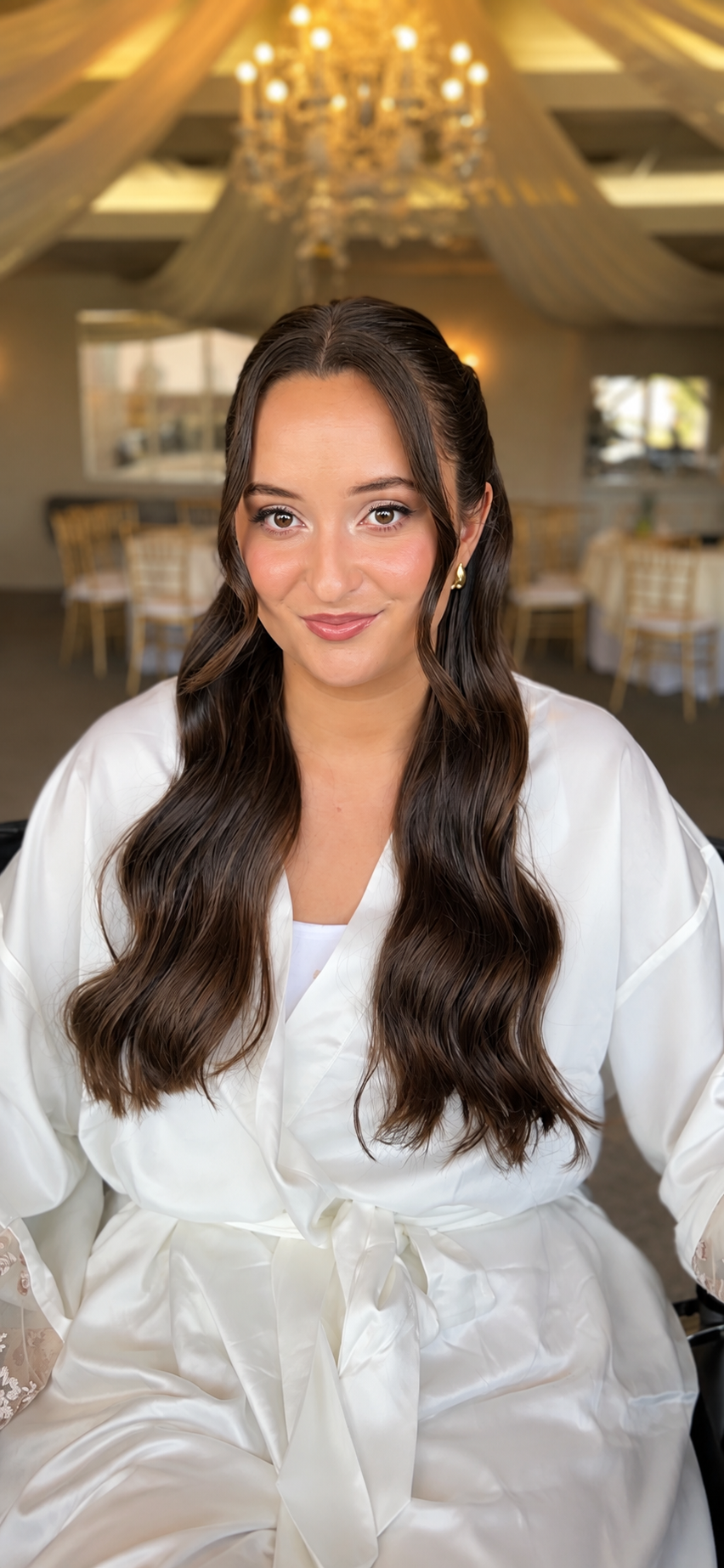 Soft, elevated bridal makeup with long polished waves for a wedding at The Vineyards in Simi Valley, CA