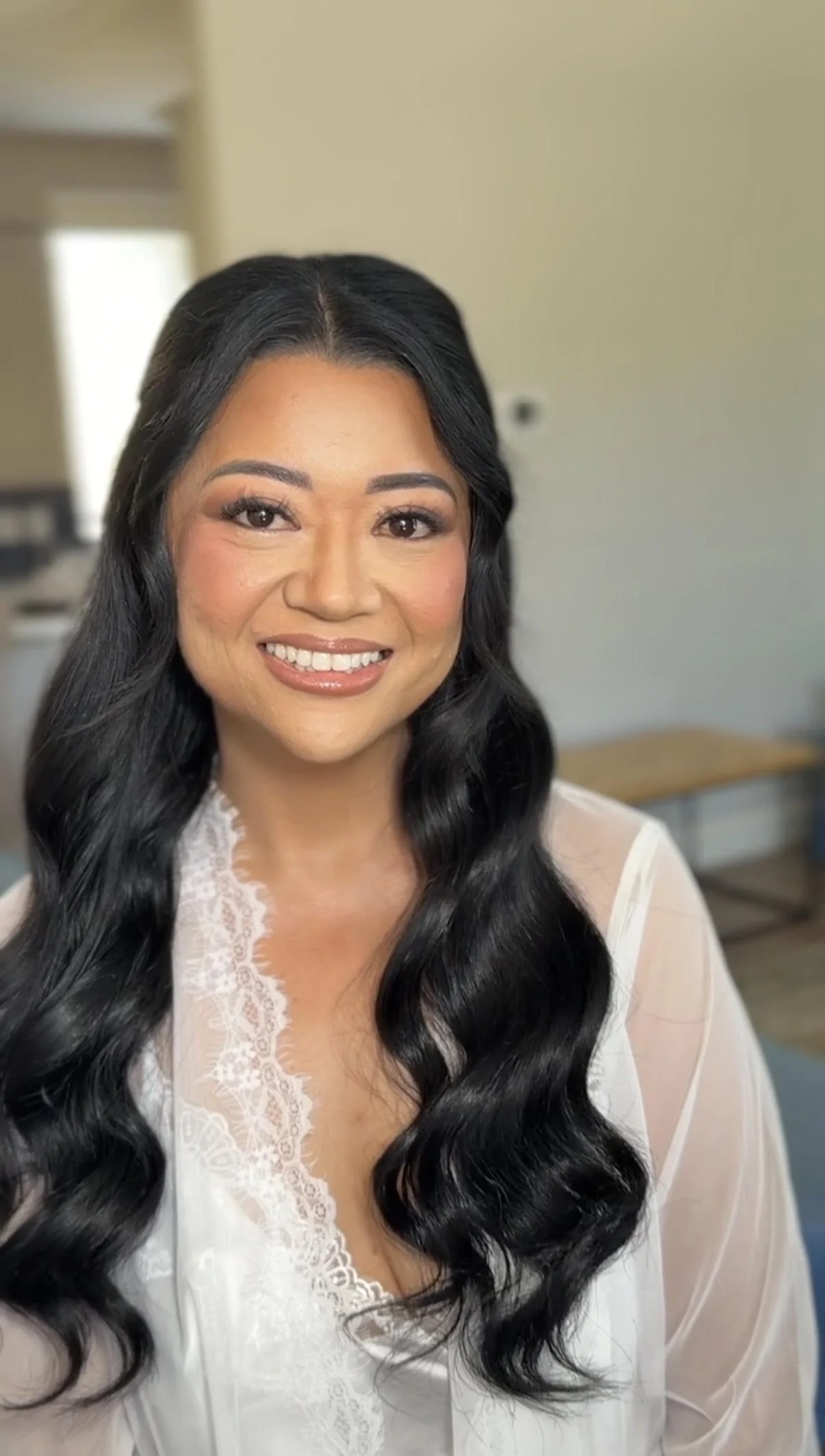 Bride with soft glam makeup and long romantic waves for her wedding at Wedgewood Weddings Fillmore & Western Railway