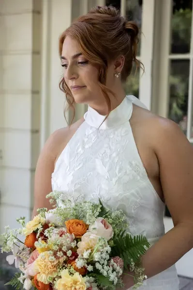 Detailed bridal beauty styling by Jazmin Urfanga beauty, featuring a ppolished updo and timeless wedding day makeup.