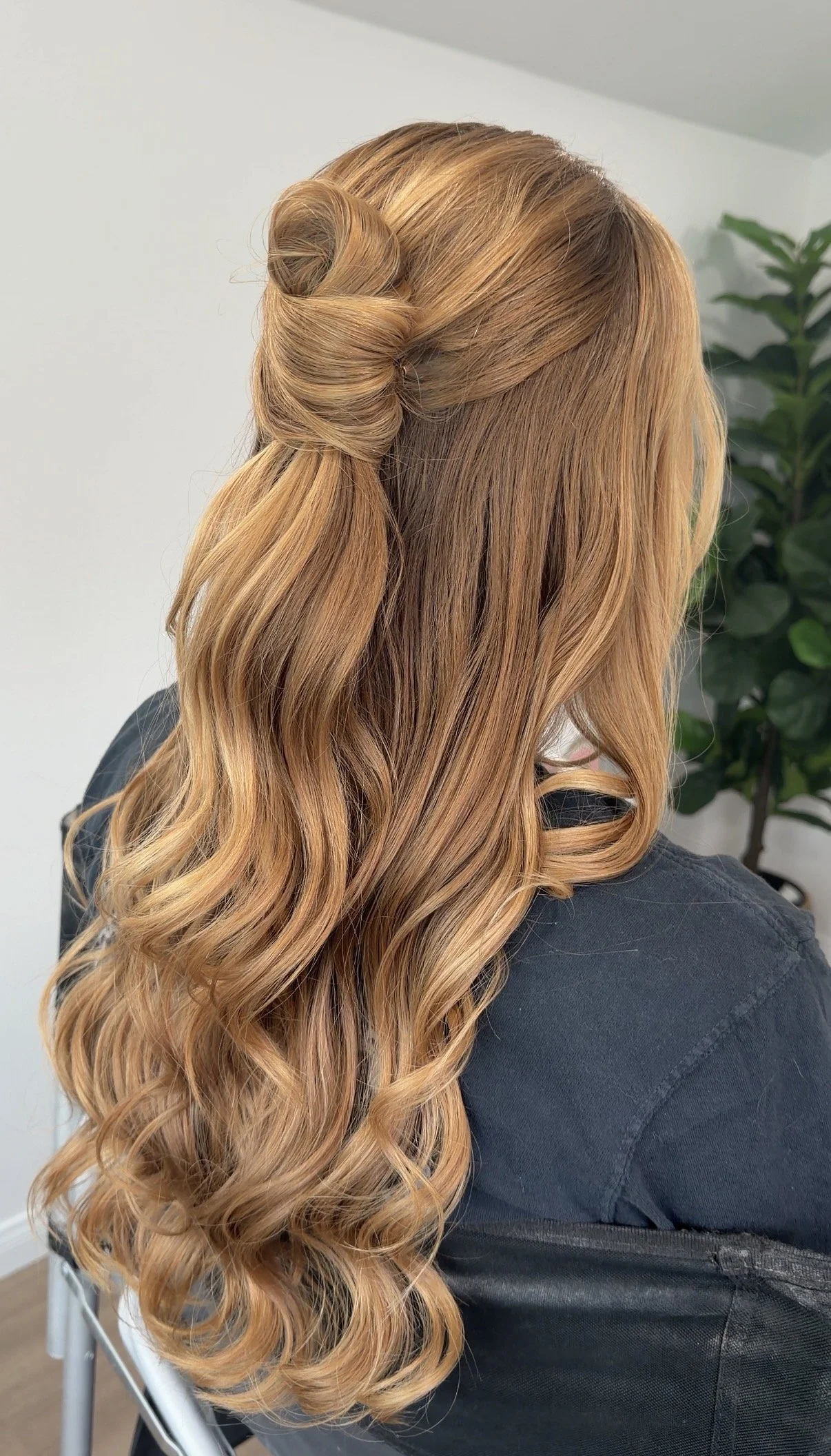 Half up French twist style with polished loose waves for a Santa Barbara Courthouse Mural Room wedding in Santa Barbara