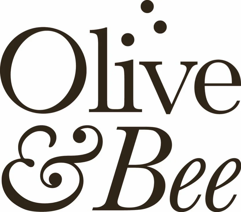 Text graphic saying 'Olive & Bee' in brown lettering with decorative dots above 'Olive' and an ampersand between the words.
