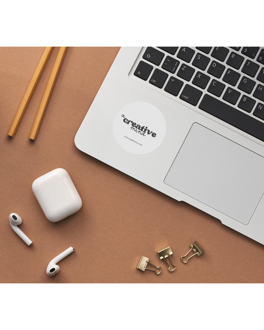 logo on laptop, laptop on desk