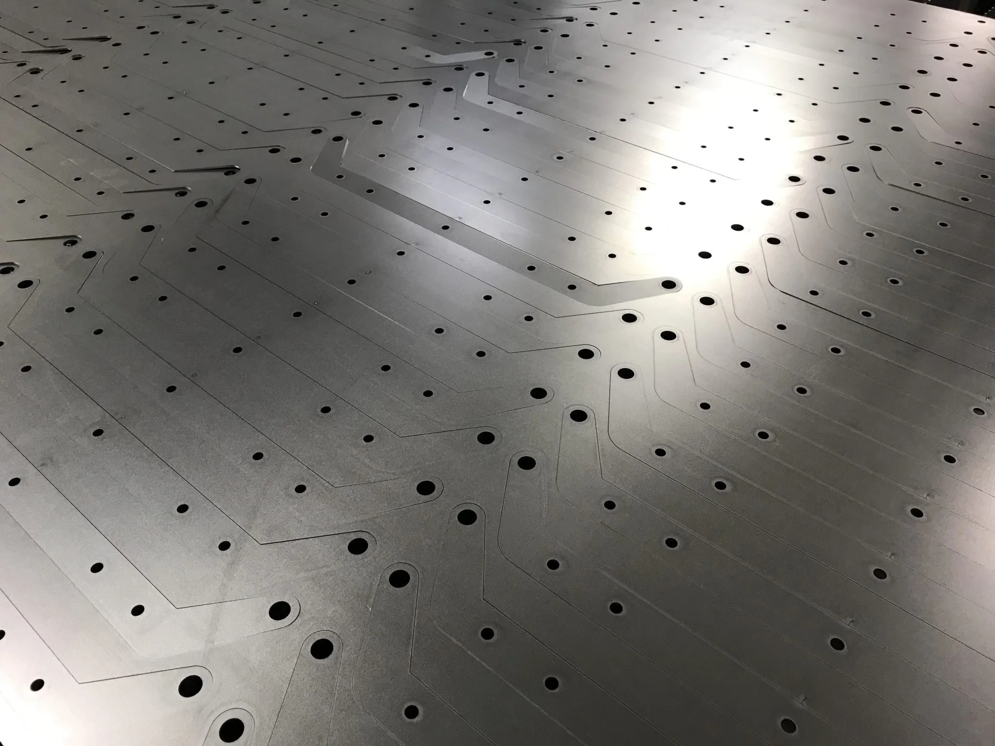 Industrial workplace office accent detailing communication paths for local laser cutting enquiries.