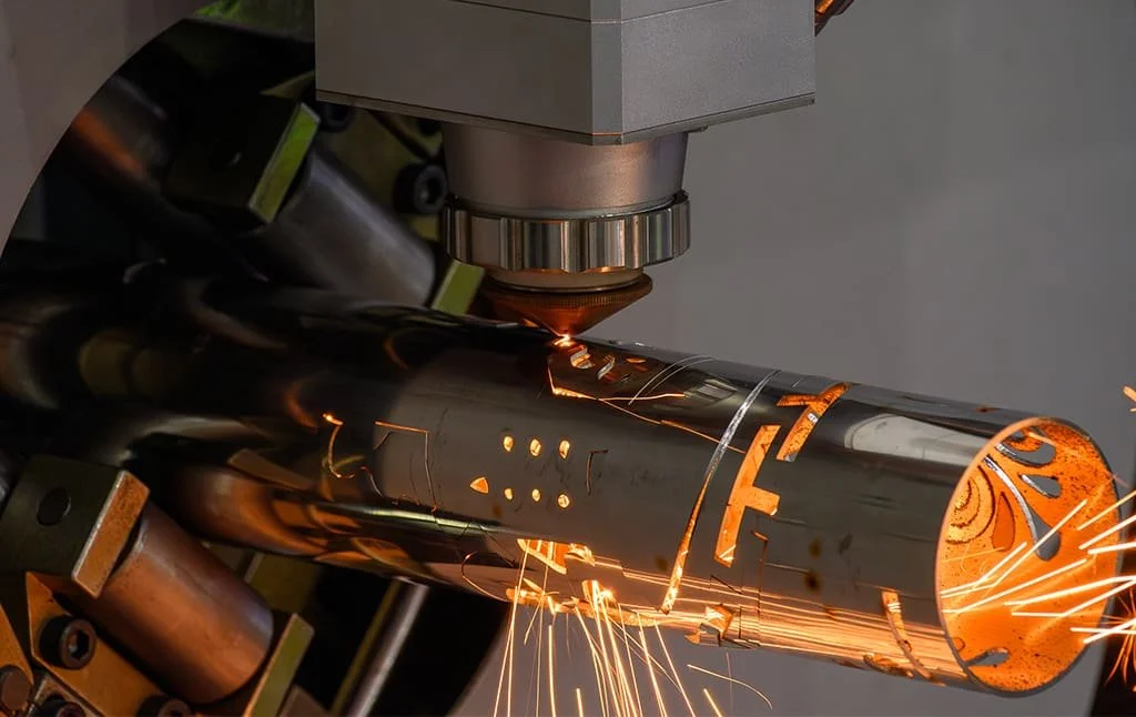 A 3D profile tube laser cutting machine automatically clamping and processing a long structural steel section.