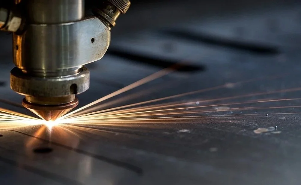 High efficiency nested steel components cleanly cut on a flatbed fiber laser cutter ready for fabrication.