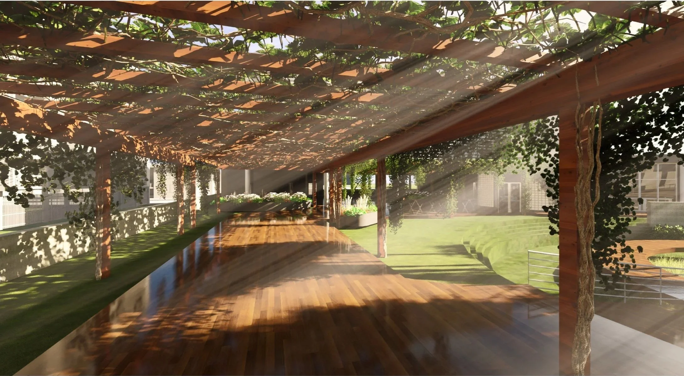 A covered outdoor patio area with wooden flooring, surrounded by trees and greenery, sunlight filtering through the leaves, and modern buildings in the background.