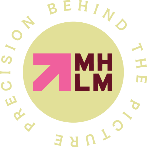 A circular logo with a black background and a beige center. Inside, pink and brown text reads "MH L M" next to a pink upward arrow. Around the beige circle, beige text says "Putting Mission Behind The Picture."