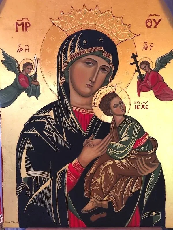 Religious icon on wood panel depicting the Virgin Mary holding baby Jesus as the Way, flanked by the archangels Michael and Gabriel who hold instruments of Christ's future Passion. Inspired by the Byzantine tradition with inscriptions in Greek, the a