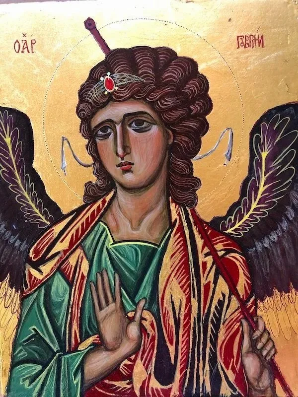 Religious icon depicting an angel with dark wings, holding a sword above its head, wearing a colorful robe, with a halo and Greek inscriptions in the background.