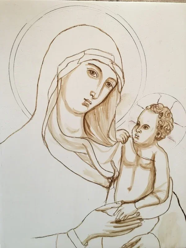 Sketch of the Virgin Mary holding the baby Jesus, both with halos around their heads.