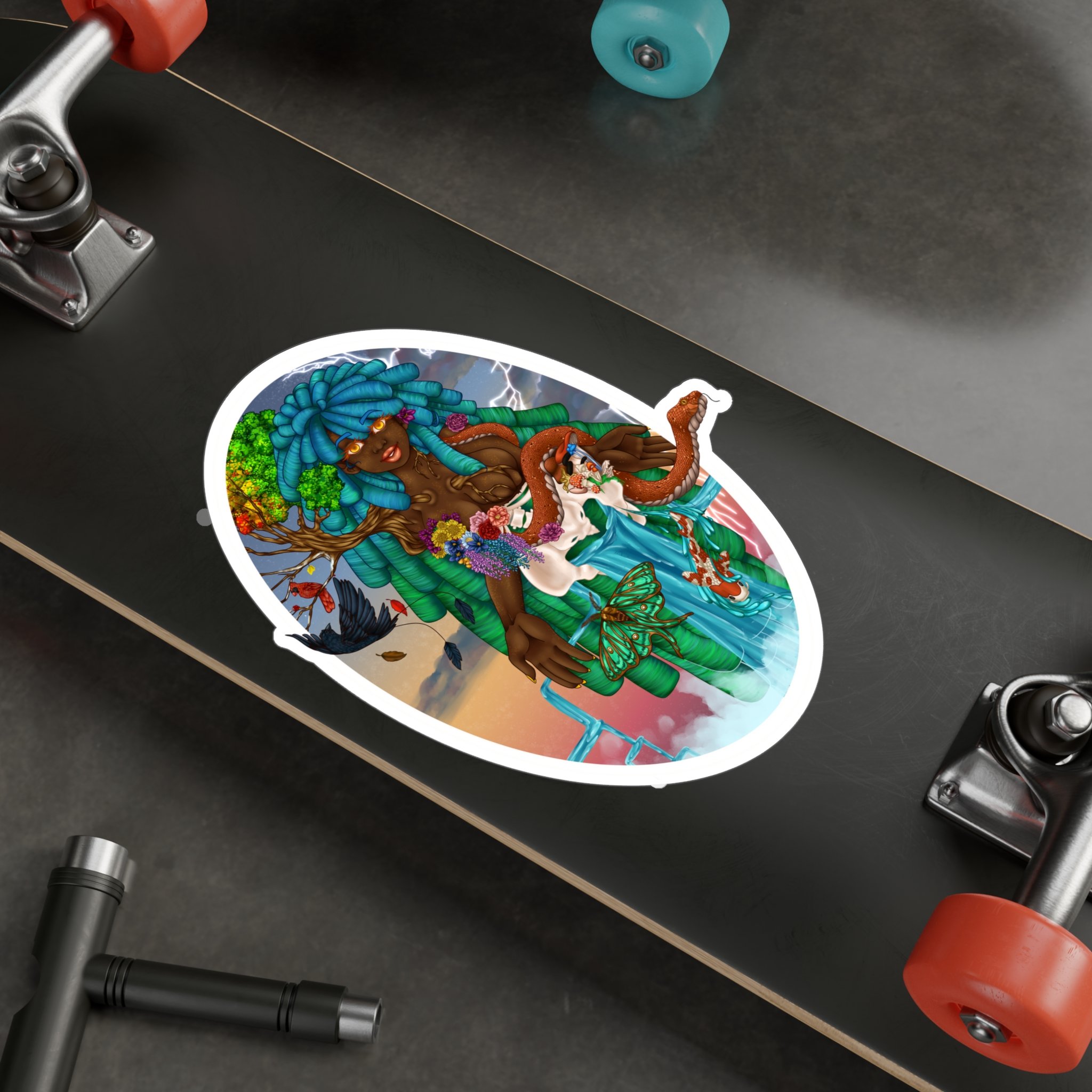 Close-up of a skateboard with colorful artwork featuring a woman with blue dreadlocks, surrounded by flowers, trees, and a snake, on a dark surface with metal pipes and a red object nearby.