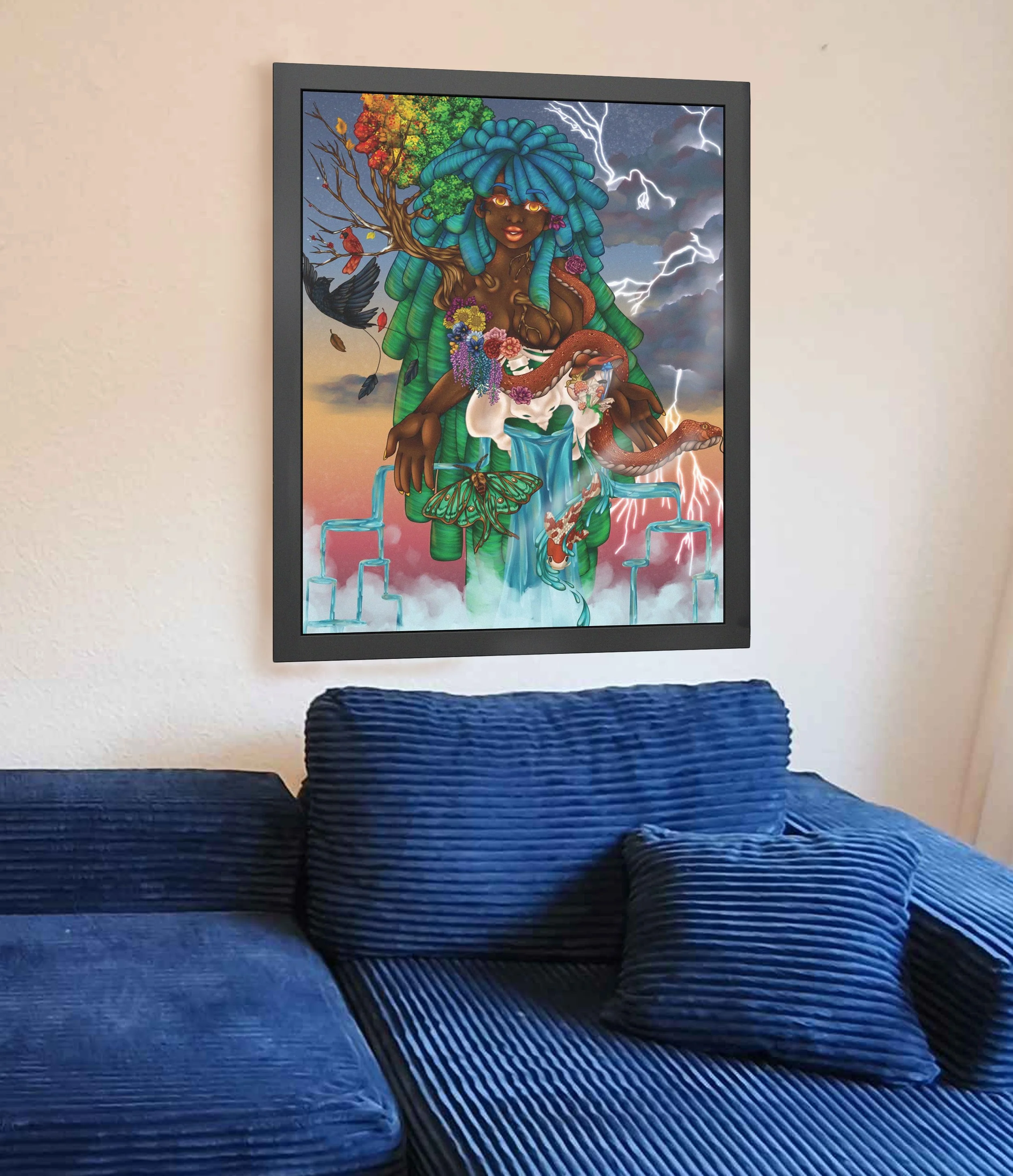 A living room with a framed tropical art print on the wall above a blue striped sofa and a matching blue pillow.