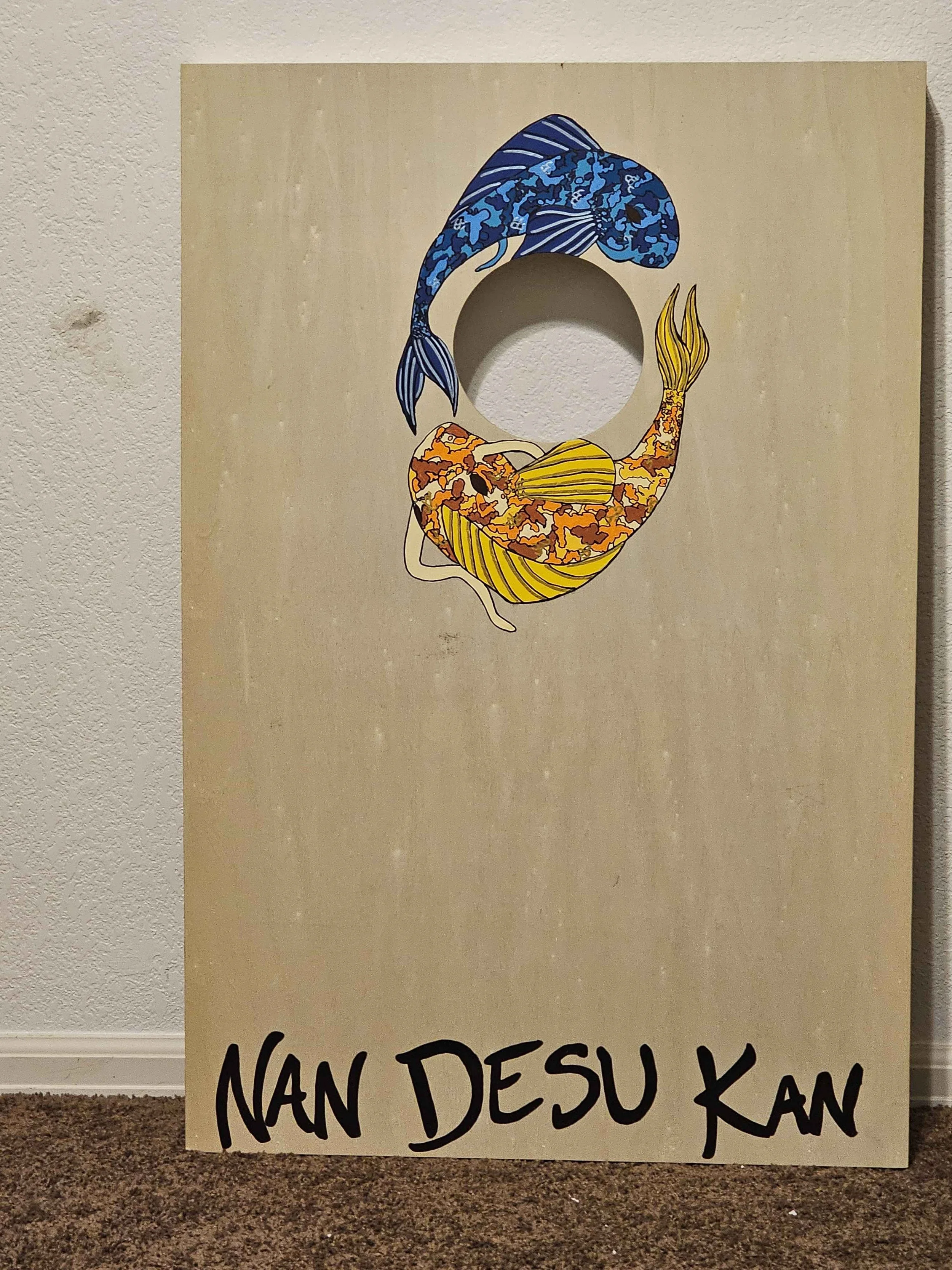 Nan Desu Kan asked for art to be done on the wood bean bag toss game. More images will grow onto the board as time goes.