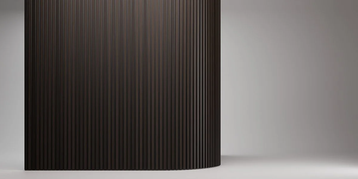 Close-up of a black, curved surface with vertical ridges next to a plain light gray background.