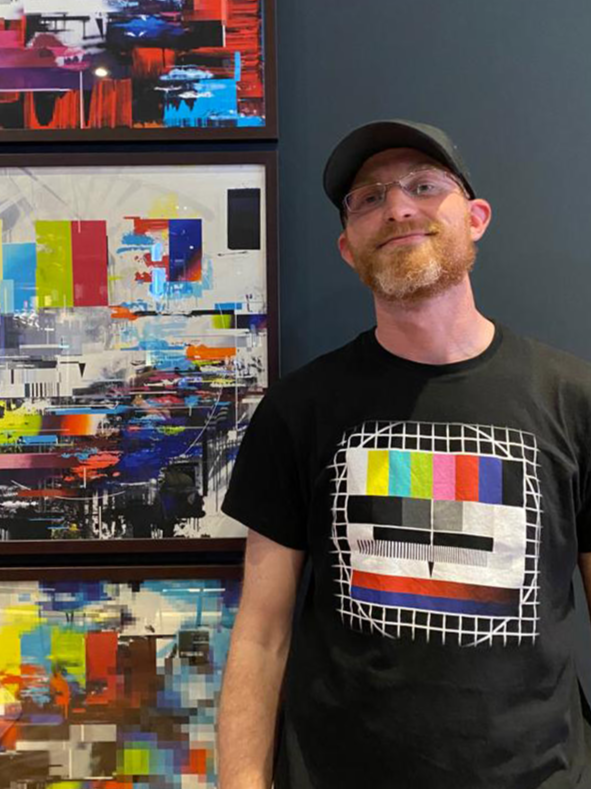 Me wearing a shirt matching the test image on the art behind me.