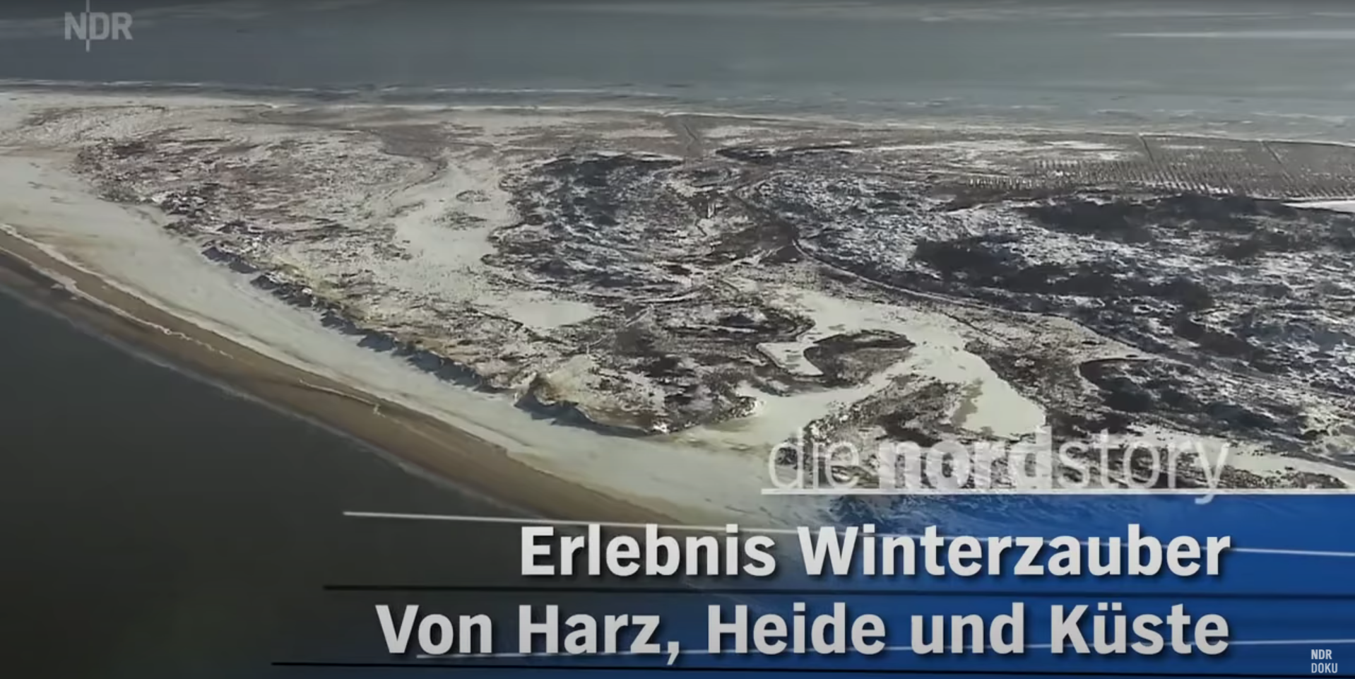 Aerial view of a snowy coastal landscape with patches of land, water, and snow, and a body of water at the top, with German text overlay about winter magic experiences from Harz, Heide, and coast.