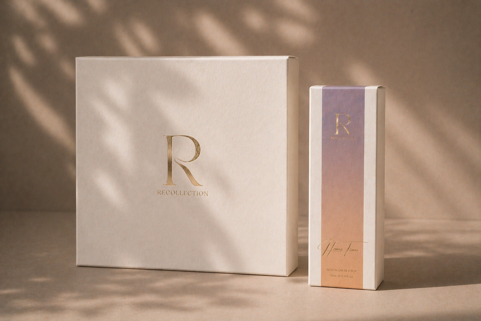 A large white box and a smaller rectangular box, both with gold lettering, are shown on a beige background with shadows and light filtering through.