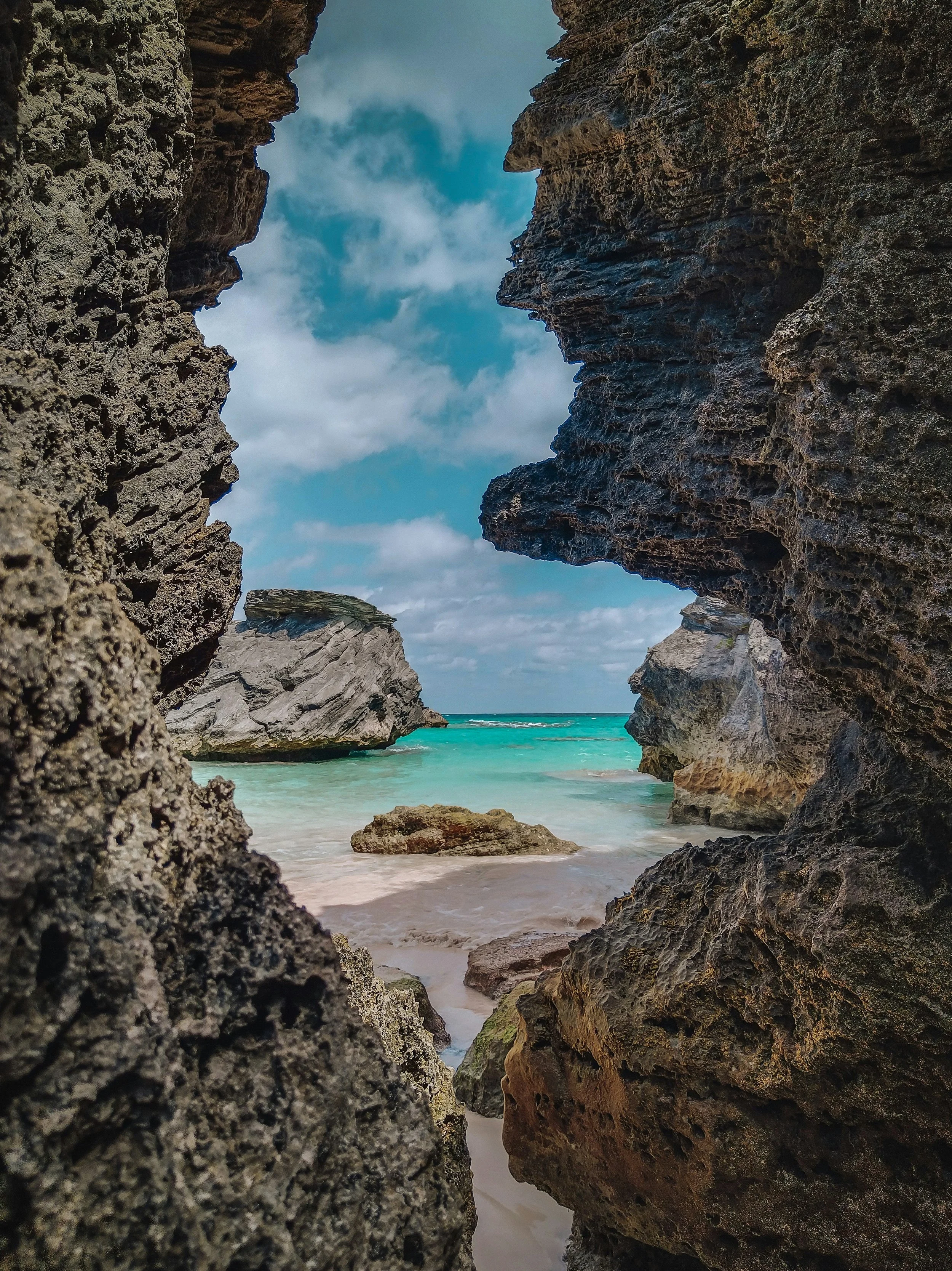 Rock formation framing Bermuda beach and ocean, symbolising resilience and structured insurance solutions provided by ASL