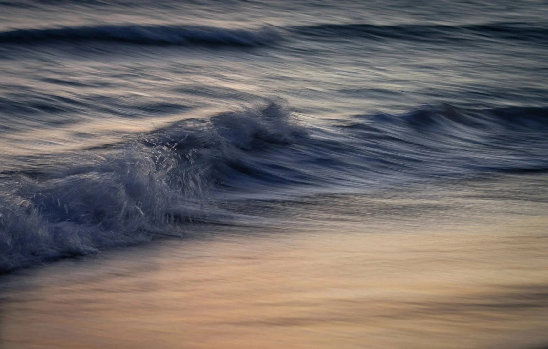 Ocean waves at sunset along Bermuda shoreline, reflecting stability and natural risk environment