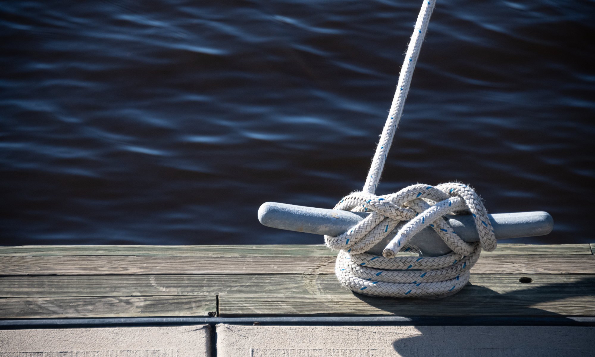 Dockside rope detail overlooking Bermuda waters, symbolising stability and local insurance environment