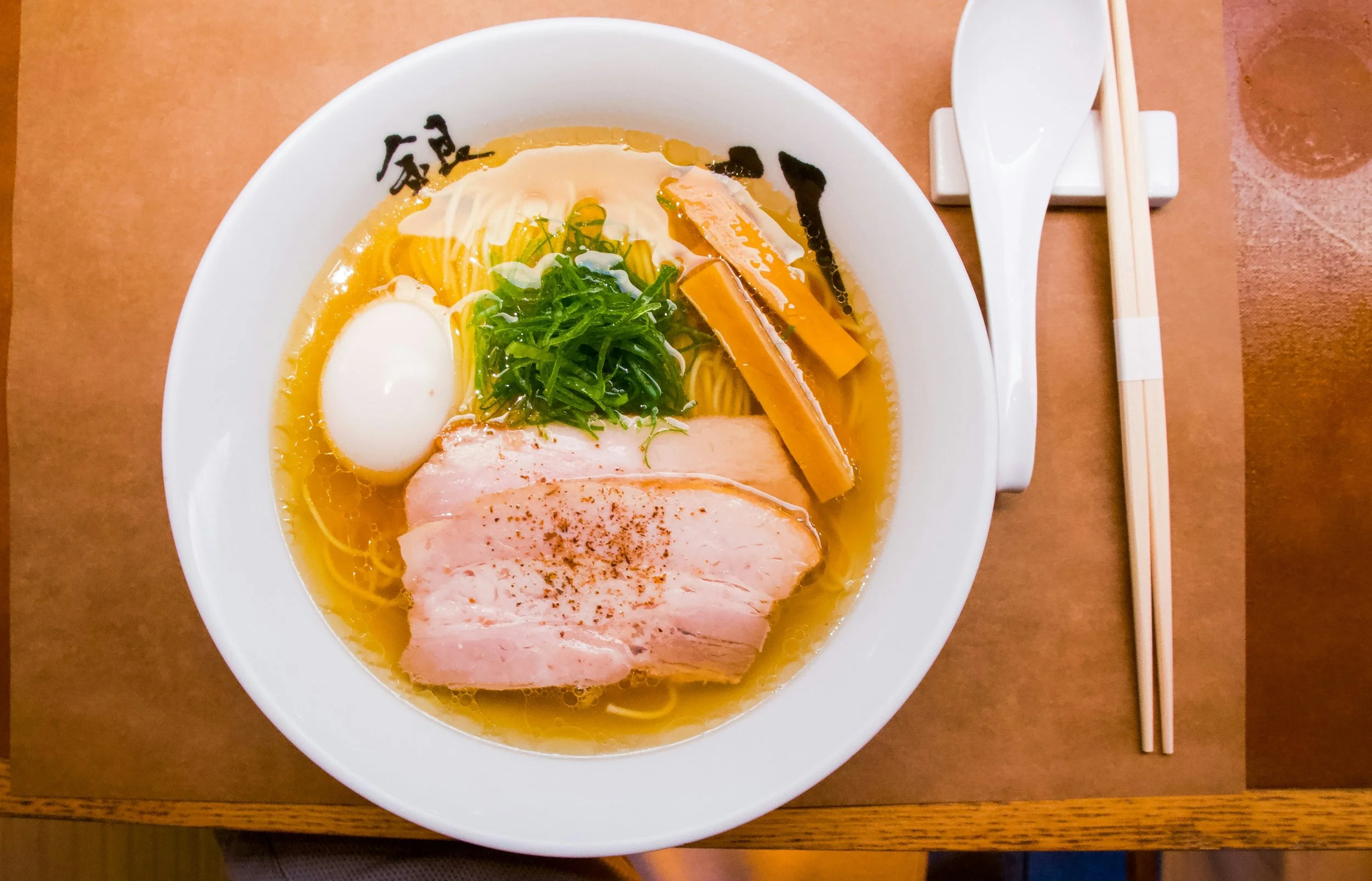 Bowl of hakata-style ramen with chashu pork, soft-boiled egg and spring onion, Japan