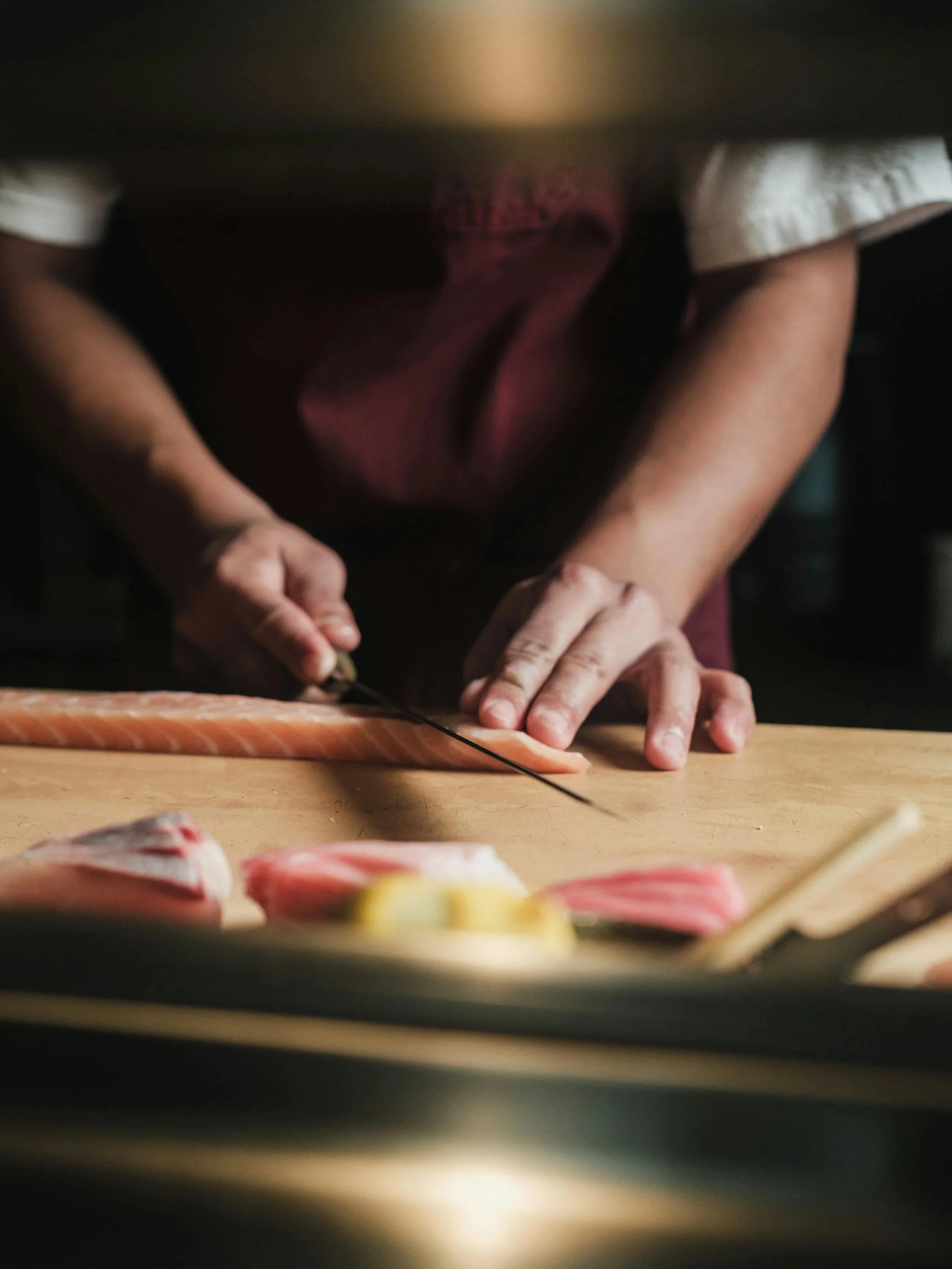 Chef preparing omakase sushi Japan — premium dining costs in Japan