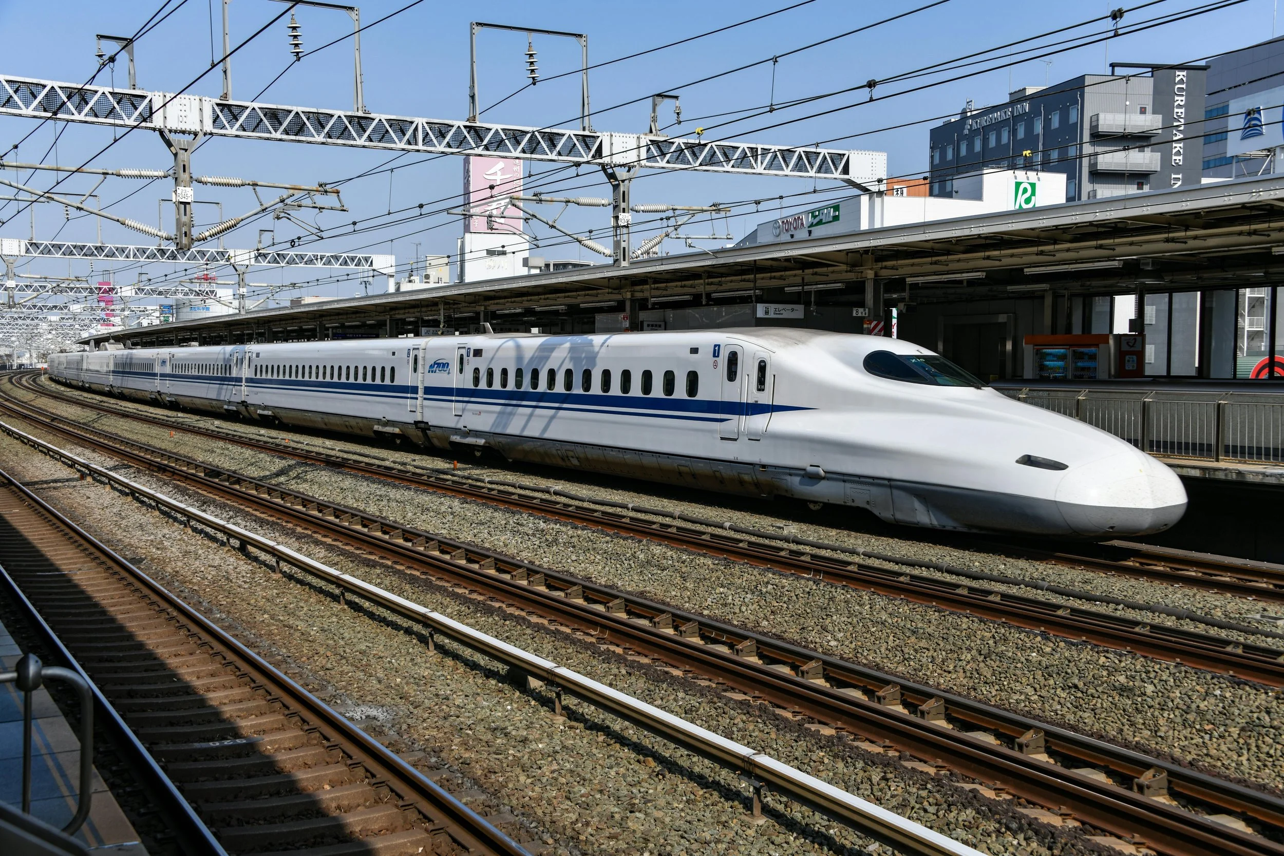Shinkansen bullet train at platform Japan — JR Pass and transport costs Australia