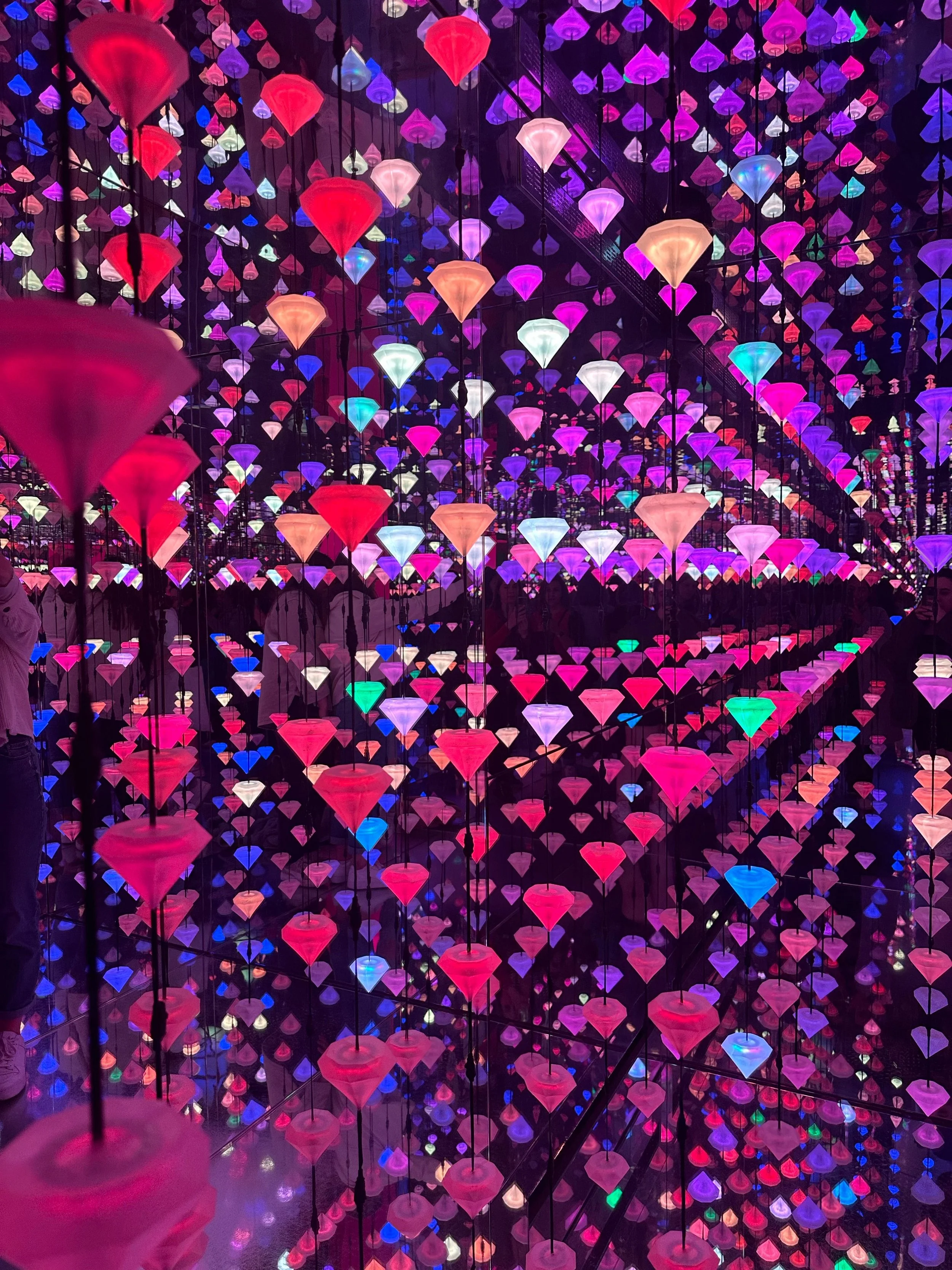 Visitors inside an immersive digital art installation in Tokyo — Japan trip cost from Australia