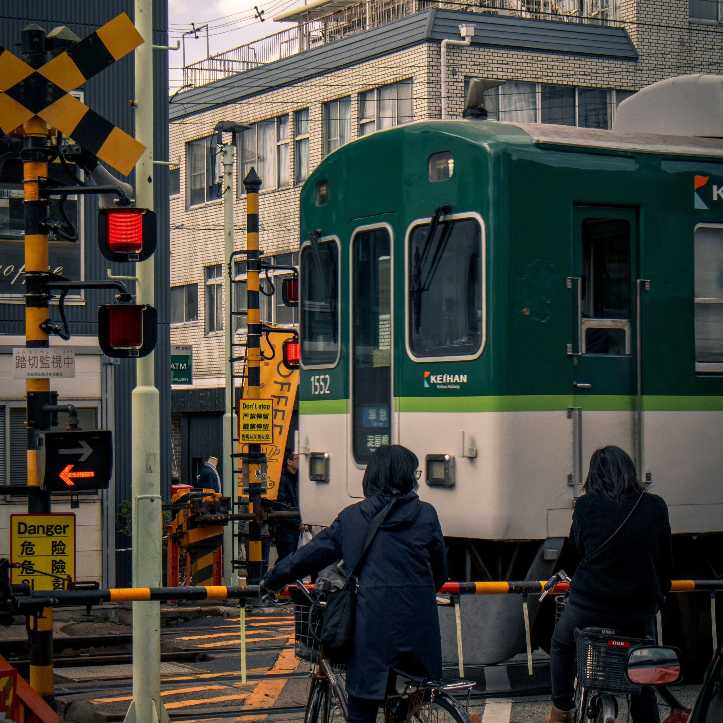 Local train crossing a street in Kyoto