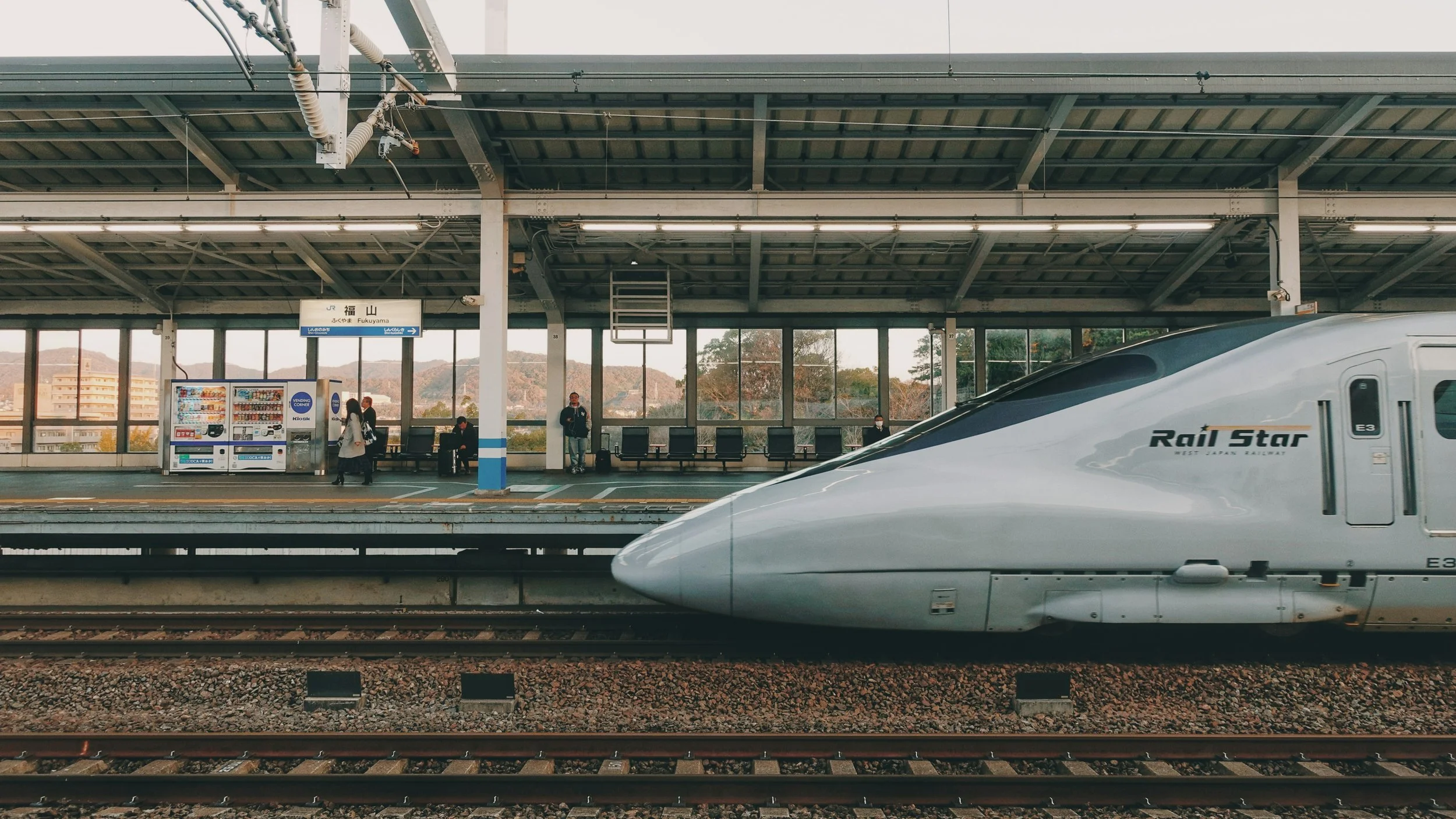 Shinkansen bullet train travelling through Japanese countryside — Japan rail travel guide by a.o.mi collective