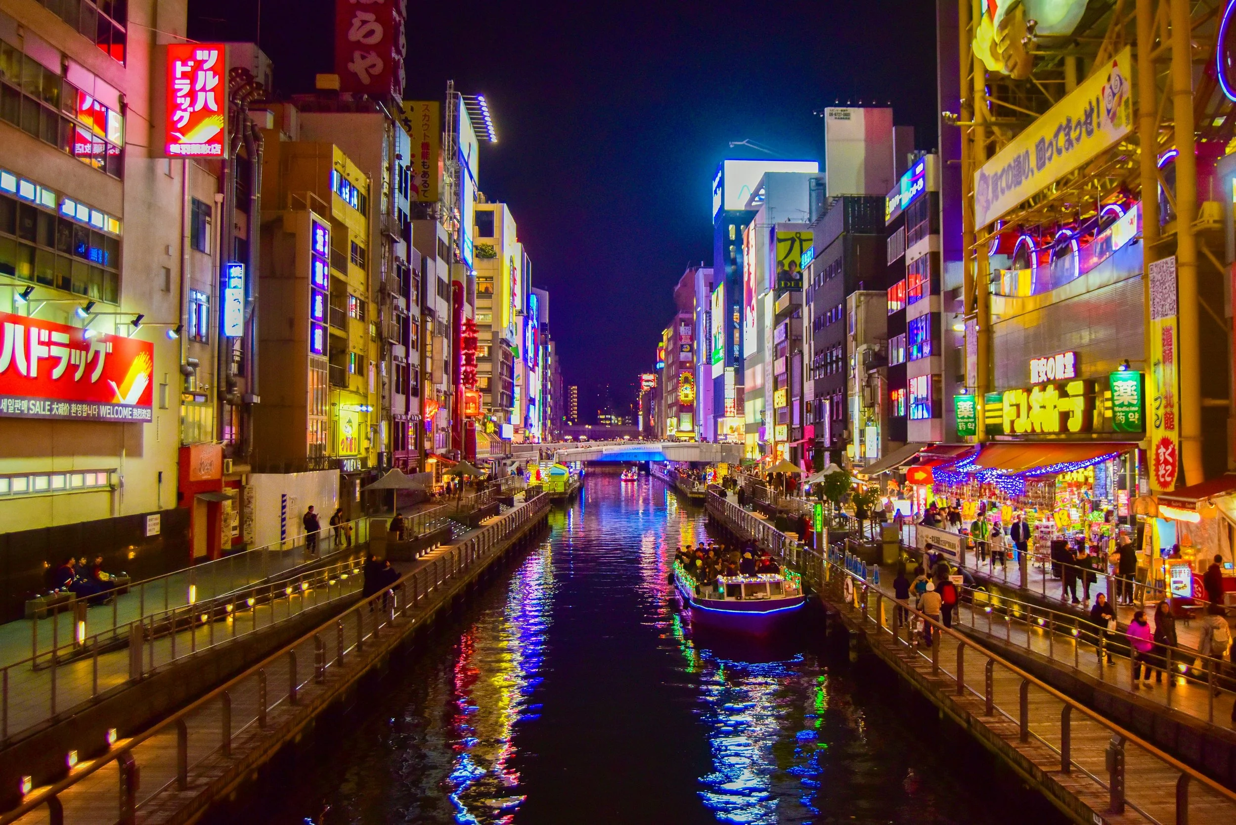 Dotonbori canal Osaka illuminated with neon signs at night — where to go in Japan first time itinerary by a.o.mi collective