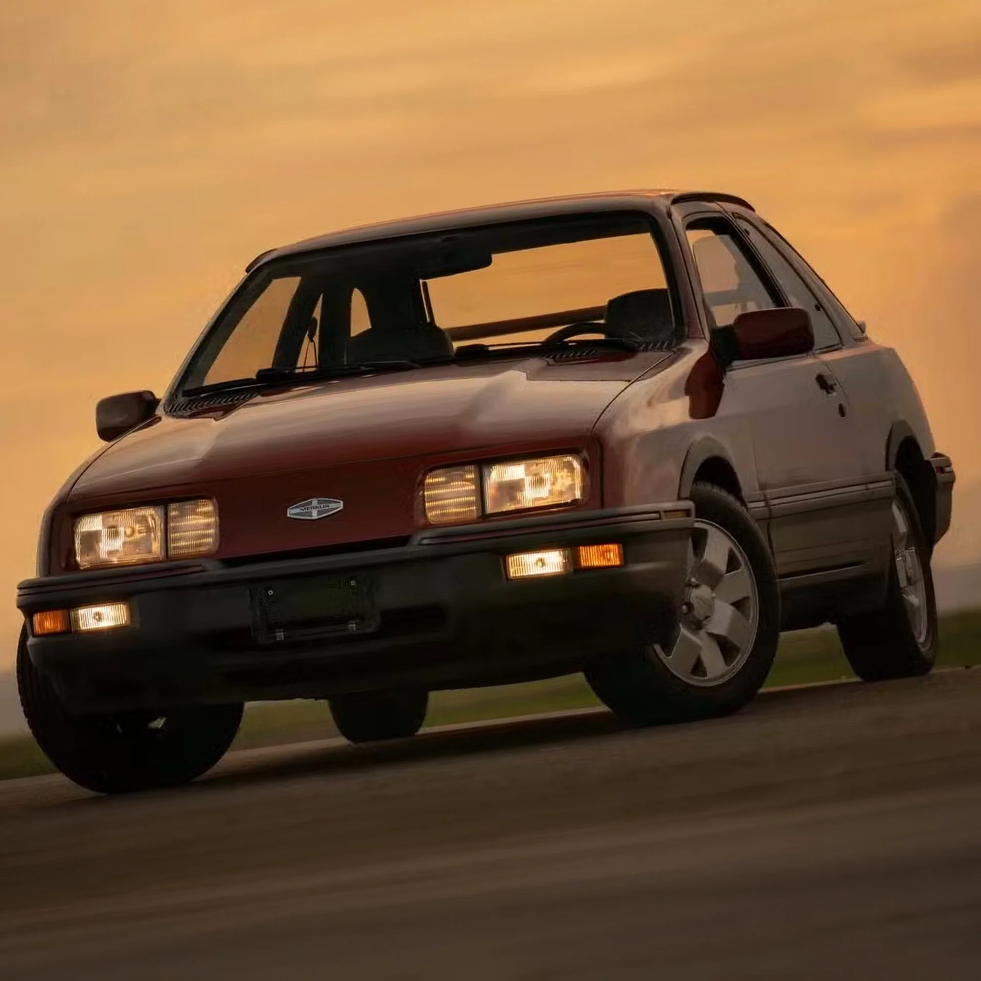 A classic red mid-1980s Nissan car driving on a road during sunset.