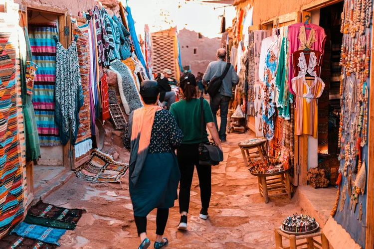 Shoppers walking through a busy Moroccan market