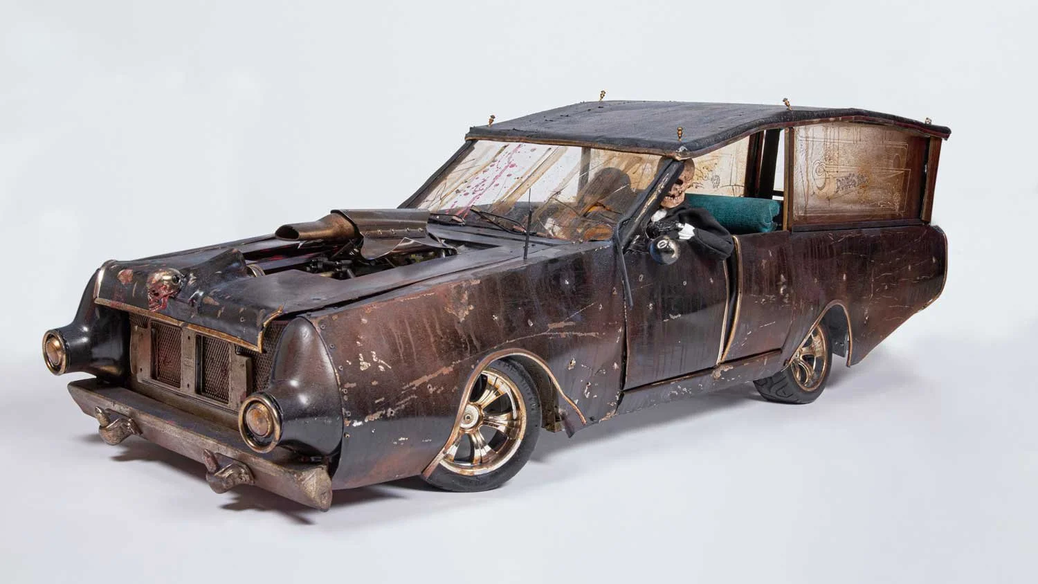 Rusty, vintage station wagon with a worn appearance, missing some parts, and a modified hood with an air intake, set against a plain white background.